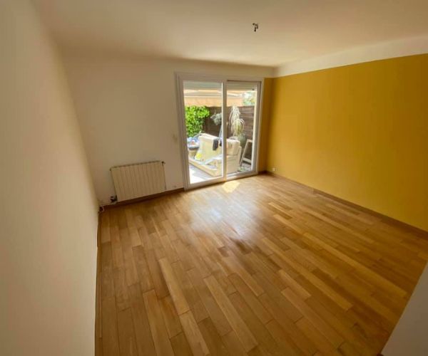 Pièce principale rénovée avec murs repeints et parquet à Martigues