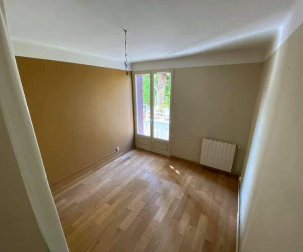 Chambre rénovée à Martigues avec murs peints et parquet